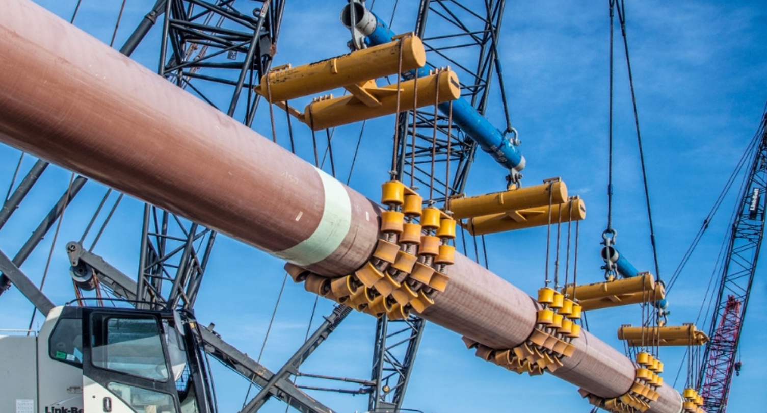 cranes lifting pipe